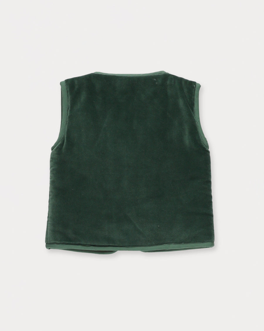 Early Sunday, Milly Baby Quilted Gilet in Forest Green, made from Cotton Velvet Velour's fabric, featuring a floral embroidery with a bow tie, shown in a back flat-lay view