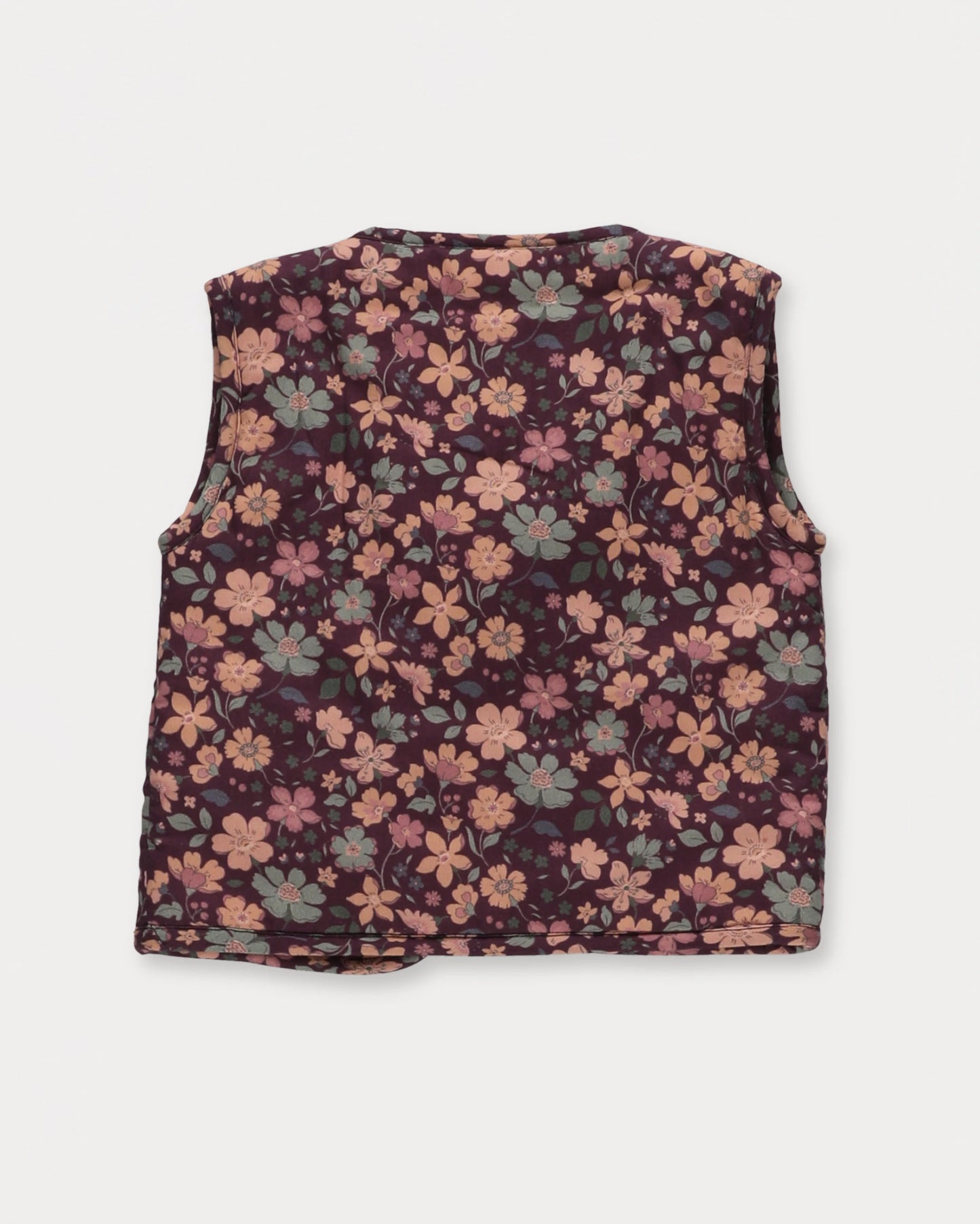 Early Sunday, Milly Baby Quilted Gilet in Garden Flowers Plum, made from Printed Cotton Satin fabric, featuring a sleeveless jacket with a bow tie, shown in a back flat-lay view