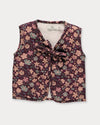 Early Sunday, Milly Baby Quilted Gilet in Garden Flowers Plum, made from Printed Cotton Satin fabric, featuring a sleeveless jacket with a bow tie, shown in a front flat-lay view