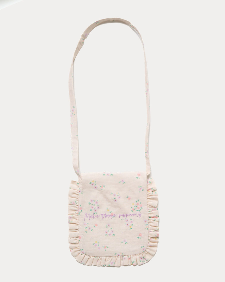Early Sunday, Miss Sunday Sling in Painted Bouquet print, made from 70% Cotton, 30% Linen fabric, featuring a frill detailed sling purse with flap closure, shown in a back flat-lay view