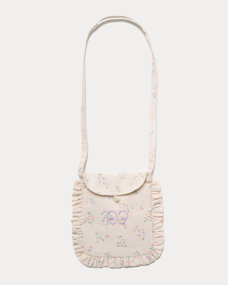 Early Sunday, Miss Sunday Sling in Painted Bouquet print, made from 70% Cotton, 30% Linen fabric, featuring a frill detailed sling purse with flap closure, shown in a front flat-lay view