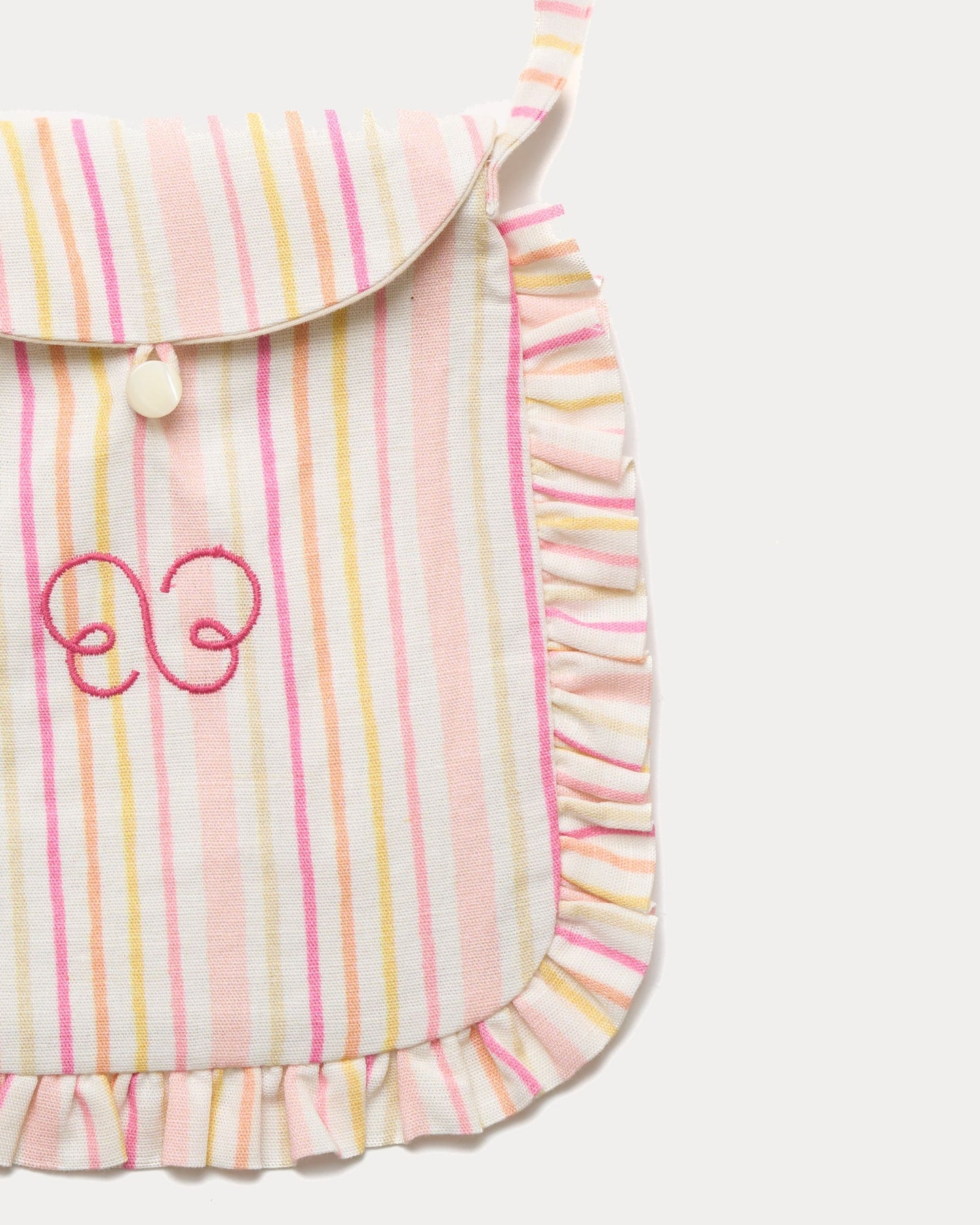Early Sunday, Miss Sunday Sling in Pink Stripes print, made from 70% Cotton, 30% Linen fabric, featuring a frill detailed sling purse with flap closure, shown in a closeup flat-lay view