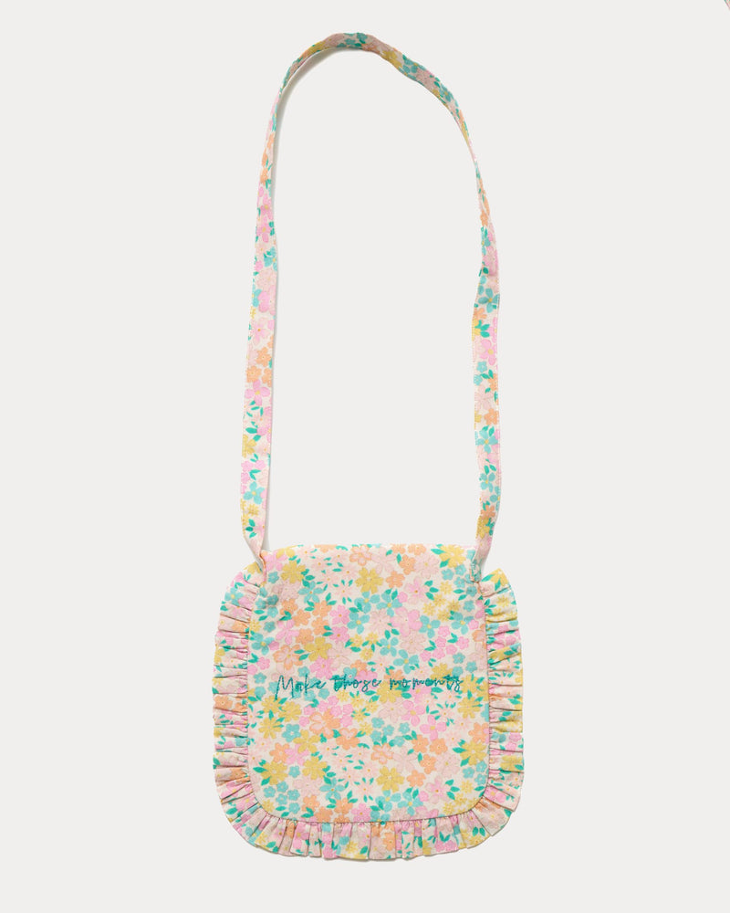 Early Sunday, Miss Sunday Sling in Emma Floral Mint color, made from Organic Printed Cotton Cambric fabric, featuring a frill detailed sling purse with flap closure, shown in back flat-lay view