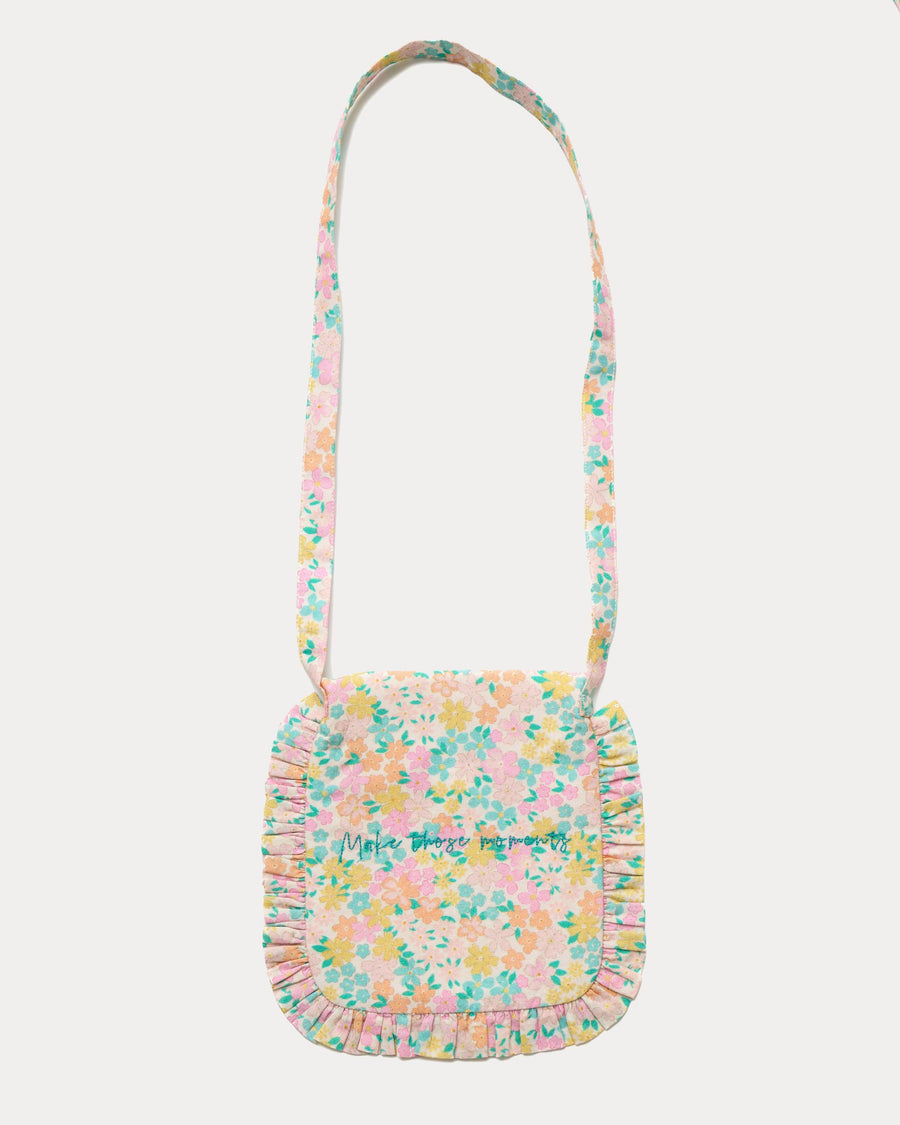 Early Sunday, Miss Sunday Sling in Emma Floral Mint color, made from Organic Printed Cotton Cambric fabric, featuring a frill detailed sling purse with flap closure, shown in back flat-lay view