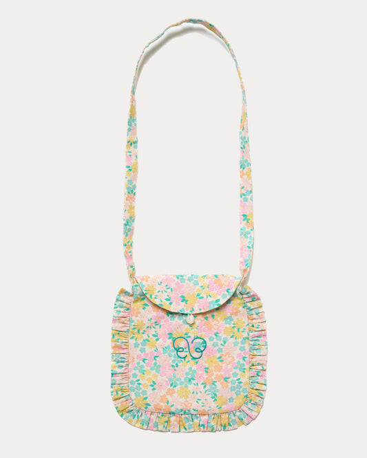 Early Sunday, Miss Sunday Sling in Emma Floral Mint color, made from Organic Printed Cotton Cambric fabric, featuring a frill detailed sling purse with flap closure, shown in front flat-lay view