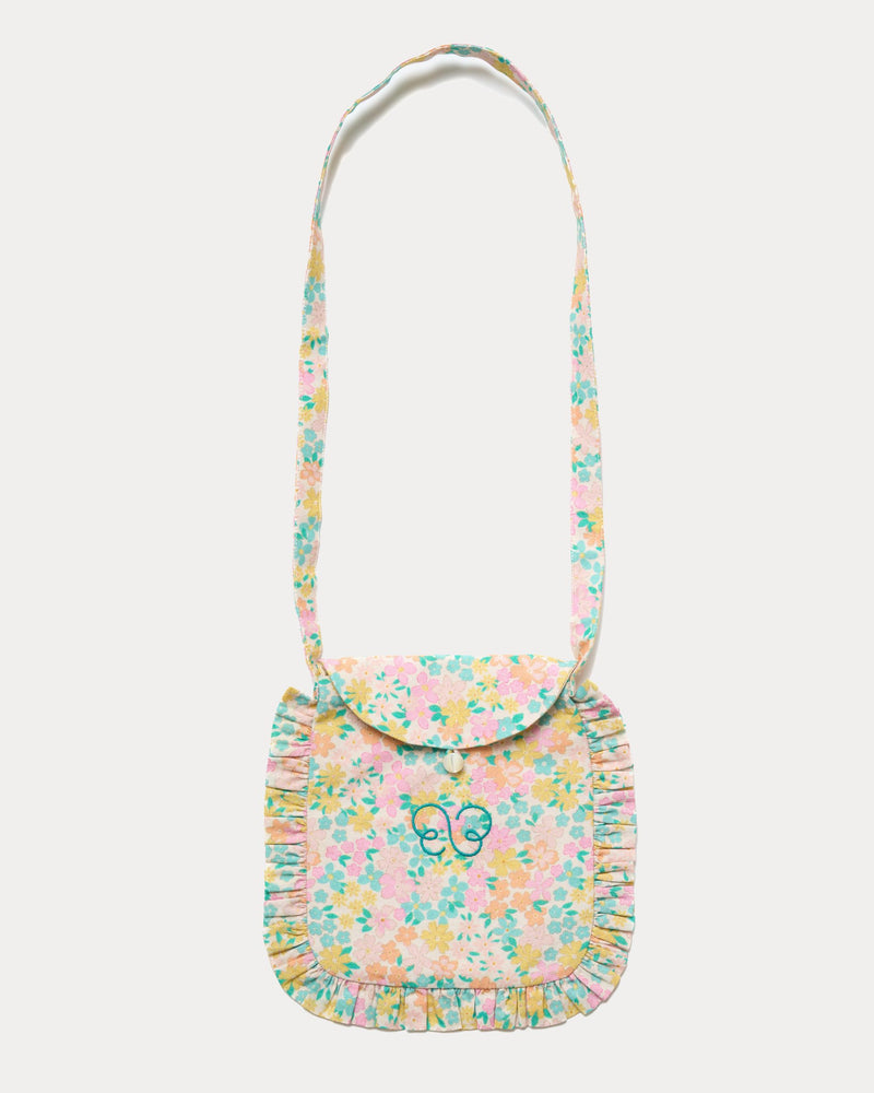 Early Sunday, Miss Sunday Sling in Emma Floral Mint color, made from Organic Printed Cotton Cambric fabric, featuring a frill detailed sling purse with flap closure, shown in front flat-lay view