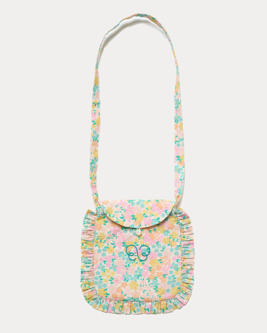 Early Sunday, Miss Sunday Sling in Emma Floral Mint color, made from Organic Printed Cotton Cambric fabric, featuring a frill detailed sling purse with flap closure, shown in front flat-lay view