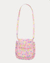 Early Sunday, Miss Sunday Sling in Emma Floral Purple color, made from Organic Printed Cotton Cambric fabric, featuring a frill detailed sling purse with flap closure, shown in back flat-lay view