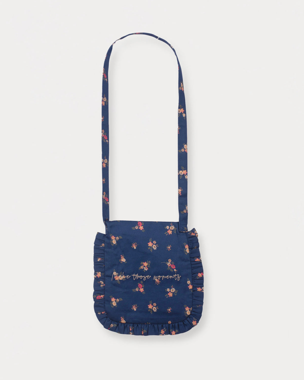 Early Sunday, Miss Sunday Sling in Ditsy Bouquet Navy Blue, made from Printed Cotton Satin fabric, featuring a frill detailed sling purse with flap closure, shown in a back flat-lay view