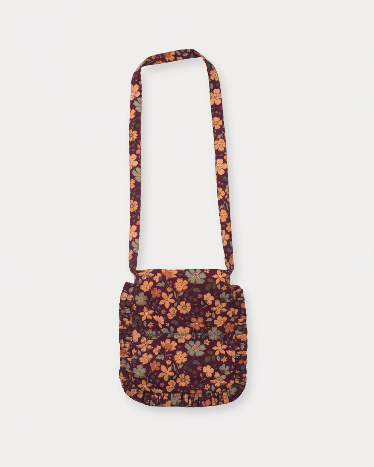 Early Sunday, Miss Sunday Sling in Garden Flowers Plum, made from Printed Cotton Satin fabric, featuring a frill detailed sling purse with flap closure, shown in a back flat-lay view