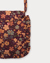 Early Sunday, Miss Sunday Sling in Garden Flowers Plum, made from Printed Cotton Satin fabric, featuring a frill detailed sling purse with flap closure, shown in a closeup flat-lay view