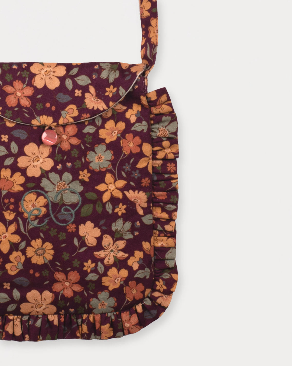 Early Sunday, Miss Sunday Sling in Garden Flowers Plum, made from Printed Cotton Satin fabric, featuring a frill detailed sling purse with flap closure, shown in a closeup flat-lay view