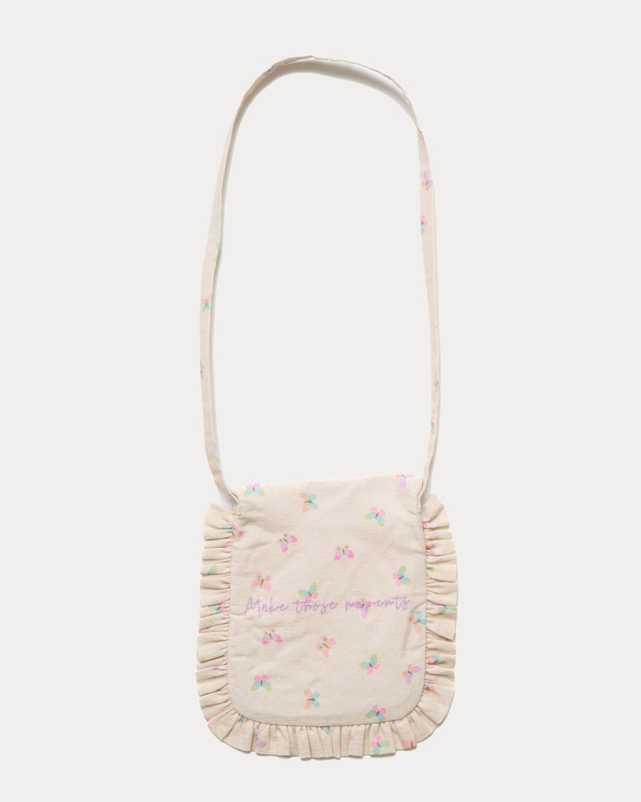 Early Sunday, Miss Sunday Sling in Butterflies print, made from Printed Cotton Tiny Swiss Dobby fabric, featuring a frill detailed sling purse with flap closure, shown in a back flat-lay view