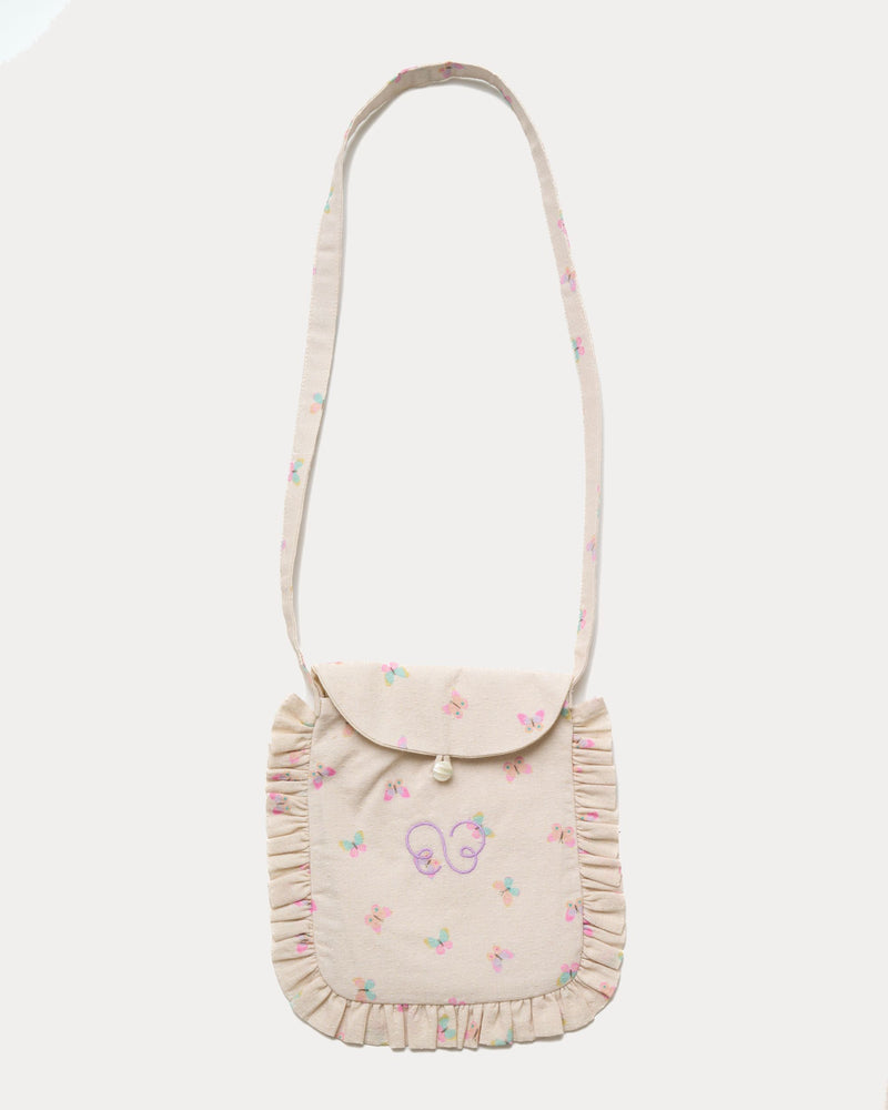 Early Sunday, Miss Sunday Sling in Butterflies print, made from Printed Cotton Tiny Swiss Dobby fabric, featuring a frill detailed sling purse with flap closure, shown in a front flat-lay view