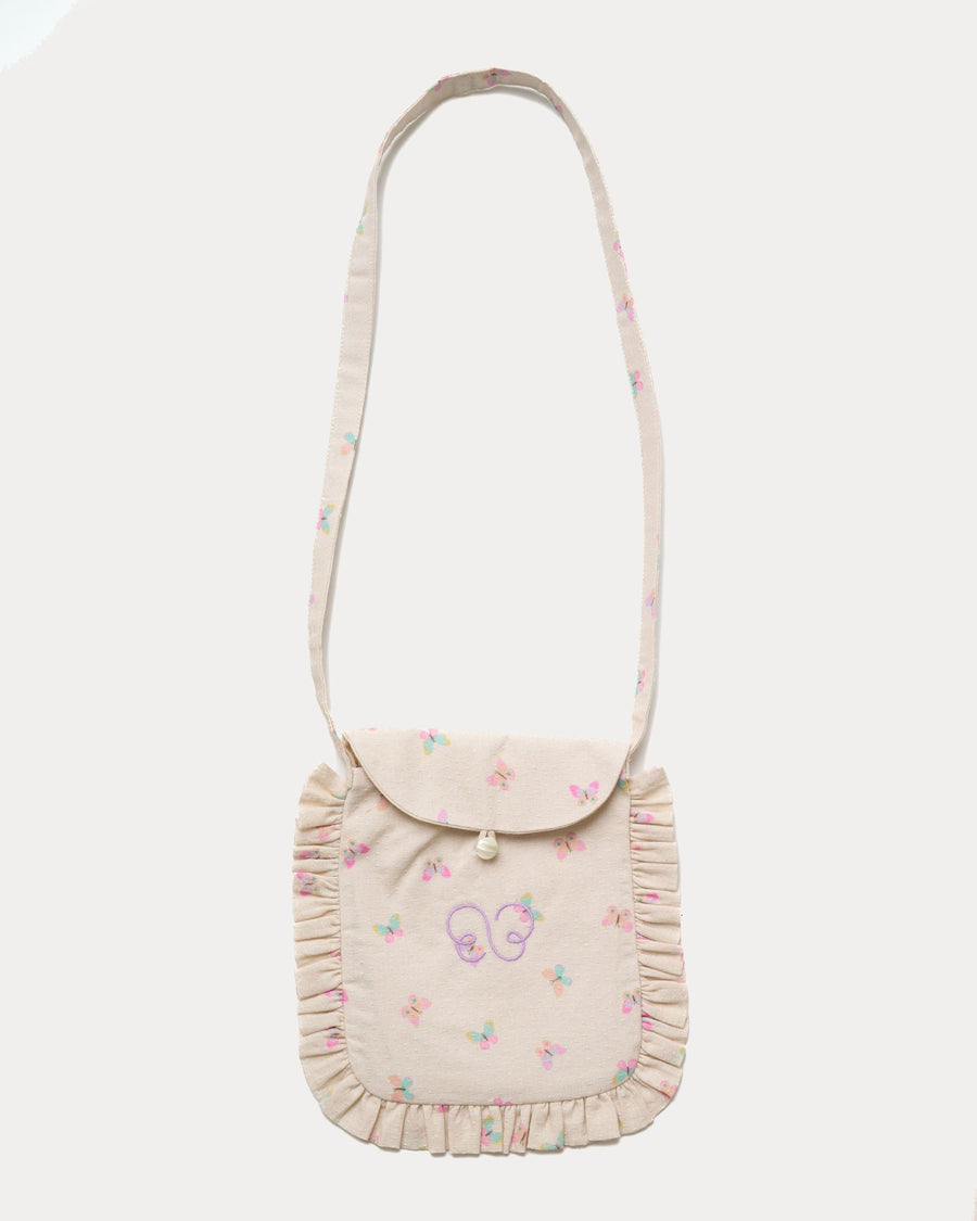 Early Sunday, Miss Sunday Sling in Butterflies print, made from Printed Cotton Tiny Swiss Dobby fabric, featuring a frill detailed sling purse with flap closure, shown in a front flat-lay view