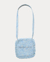 Early Sunday, Miss Sunday Sling in Tonal Floral Blue color, made from Printed Cotton Tiny Swiss Dobby fabric, featuring a frill detailed sling purse with flap closure, shown in back flat-lay view