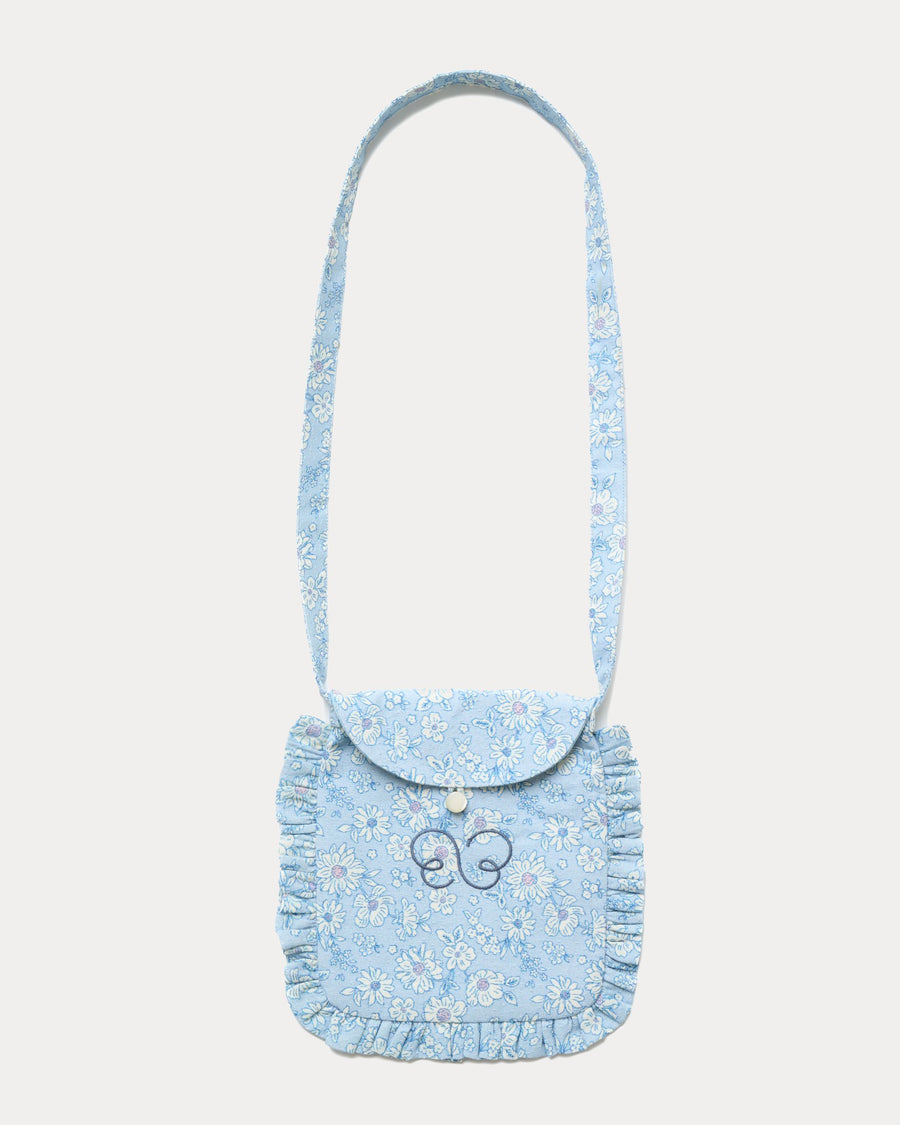 Early Sunday, Miss Sunday Sling in Tonal Floral Blue color, made from Printed Cotton Tiny Swiss Dobby fabric, featuring a frill detailed sling purse with flap closure, shown in front flat-lay view