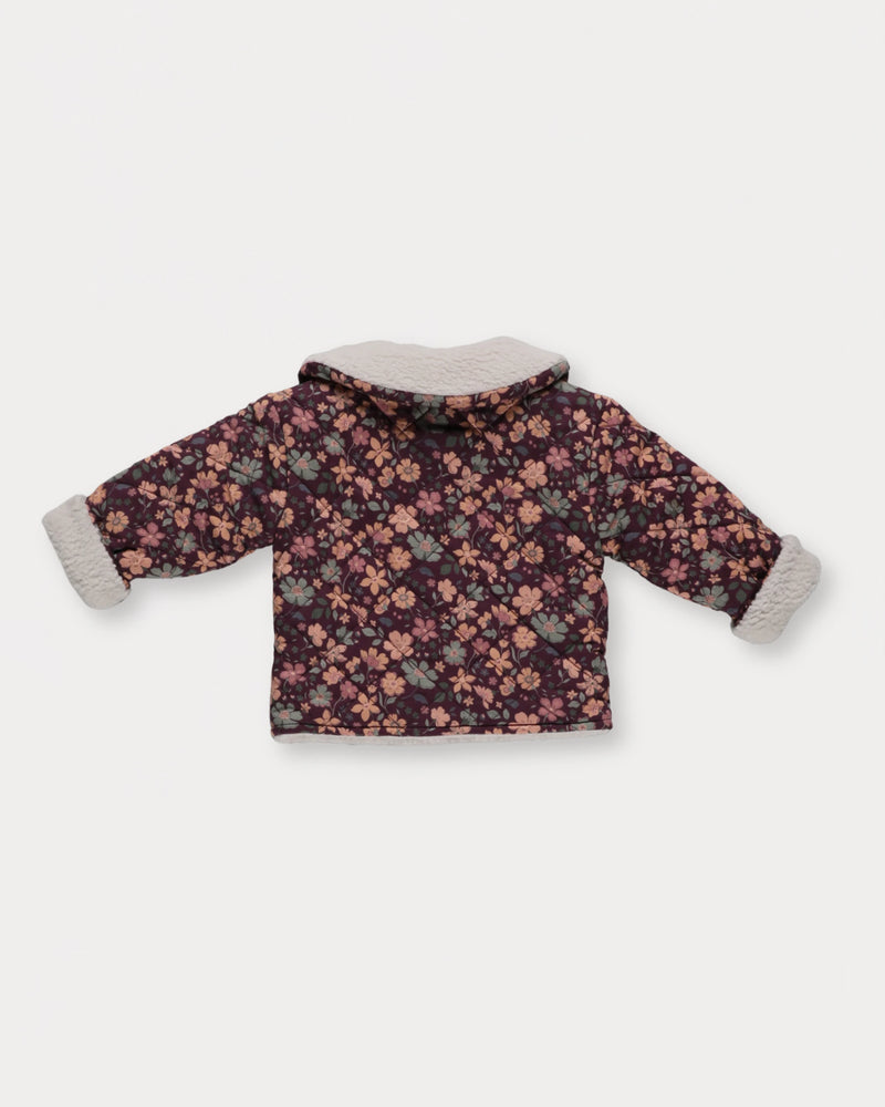Early Sunday, Molly Baby Quilted Jacket in Garden Flowers Plum, made from Printed Cotton Satin fabric, featuring a sherpa collar & cuffed sleeves, shown in a back flat-lay view