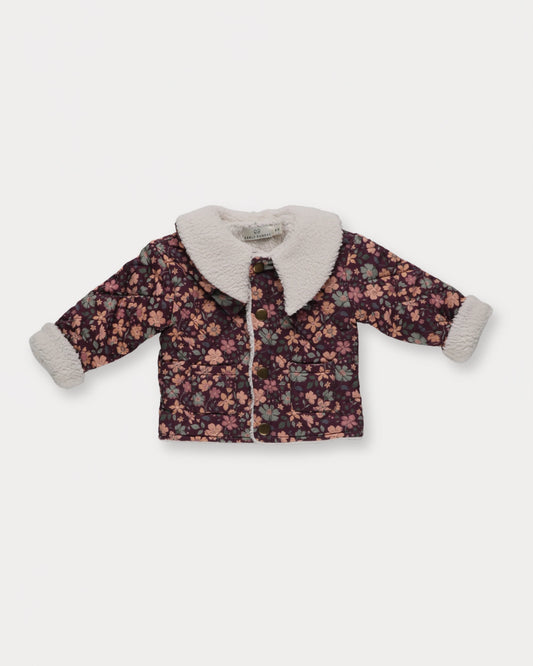 Early Sunday, Molly Baby Quilted Jacket in Garden Flowers Plum, made from Printed Cotton Satin fabric, featuring a sherpa collar & cuffed sleeves with snap button closure, shown in a closeup flat-lay view