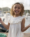 Early Sunday, Natasha Dress in Ivory color, made from 70% Cotton x 30% Linen fabric, featuring flattering fit with delicate finishes, combining style and functionality for an effortlessly elegant look, shown in a close up shot of model wearing outdoors
