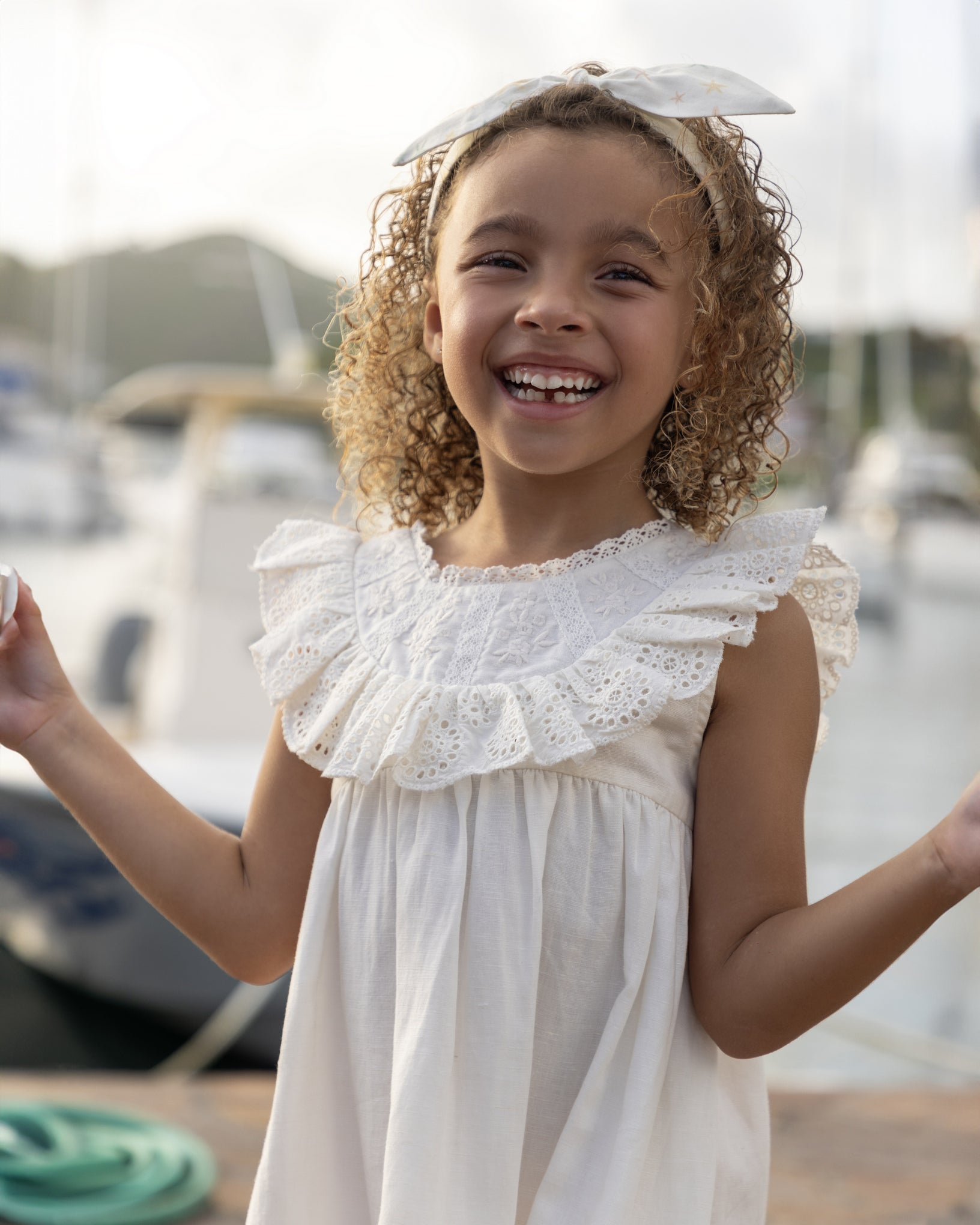 Early Sunday, Natasha Dress in Ivory color, made from 70% Cotton x 30% Linen fabric, featuring flattering fit with delicate finishes, combining style and functionality for an effortlessly elegant look, shown in a close up shot of model wearing outdoors