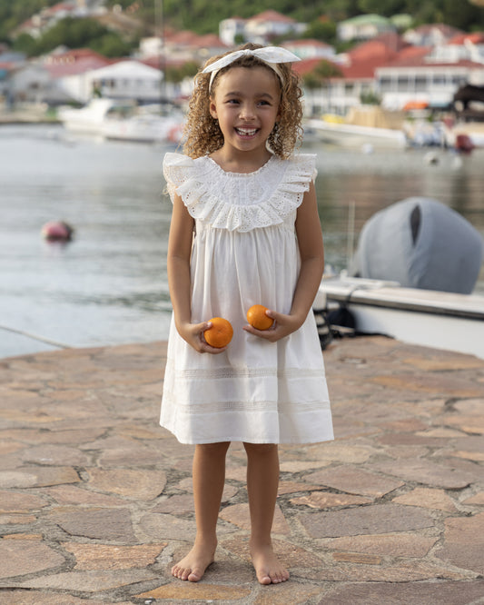 Early Sunday, Natasha Dress in Ivory color, made from 70% Cotton x 30% Linen fabric, featuring flattering fit with delicate finishes, combining style and functionality for an effortlessly elegant look, shown in a front view of model wearing it