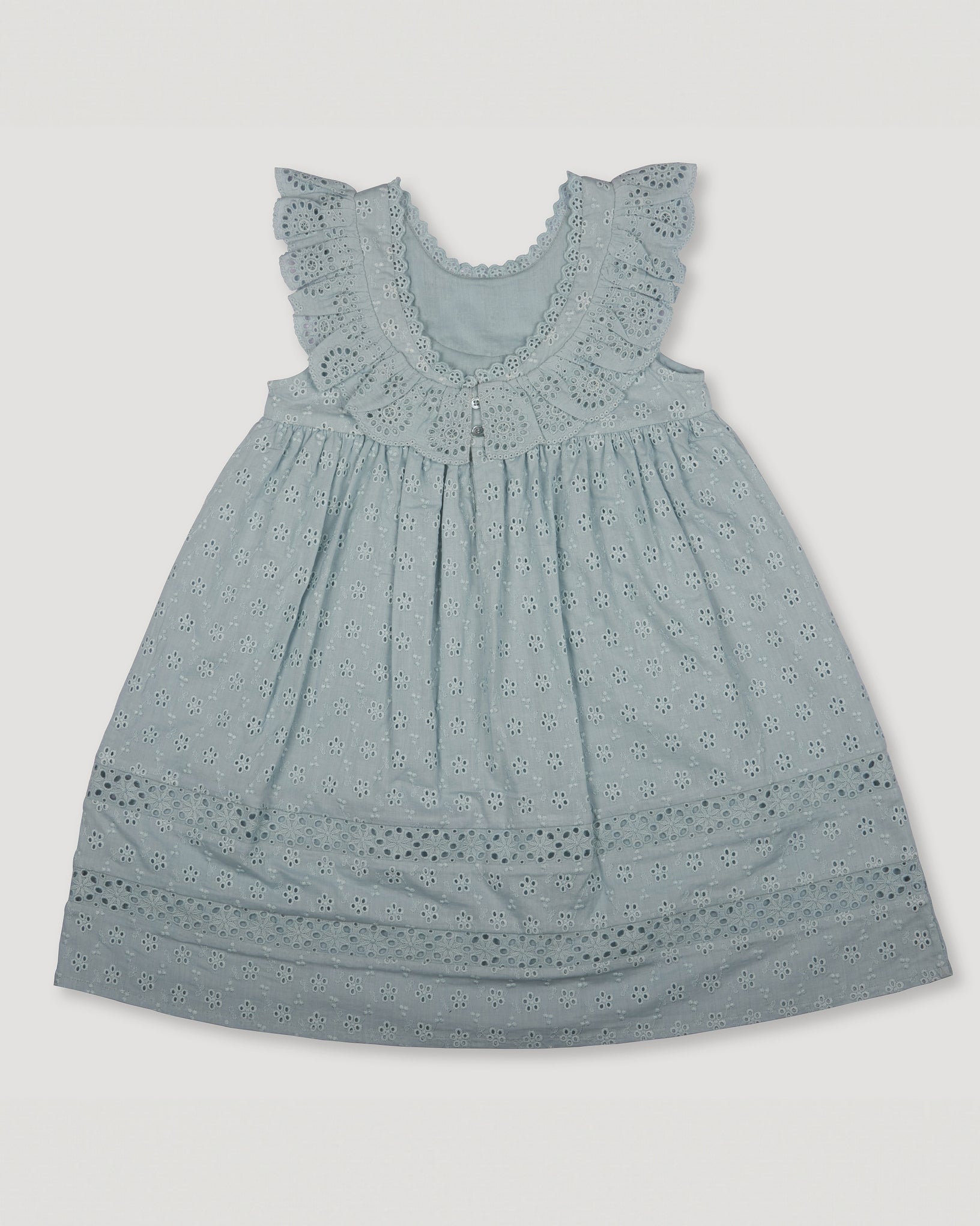 Early Sunday, Natasha Dress in Sea Dream color, made from All-Over Eyelet Embroidered Cotton Schifflie fabric, featuring flattering fit with delicate finishes, combining style and functionality for an effortlessly elegant look, shown in a back flat-lay view
