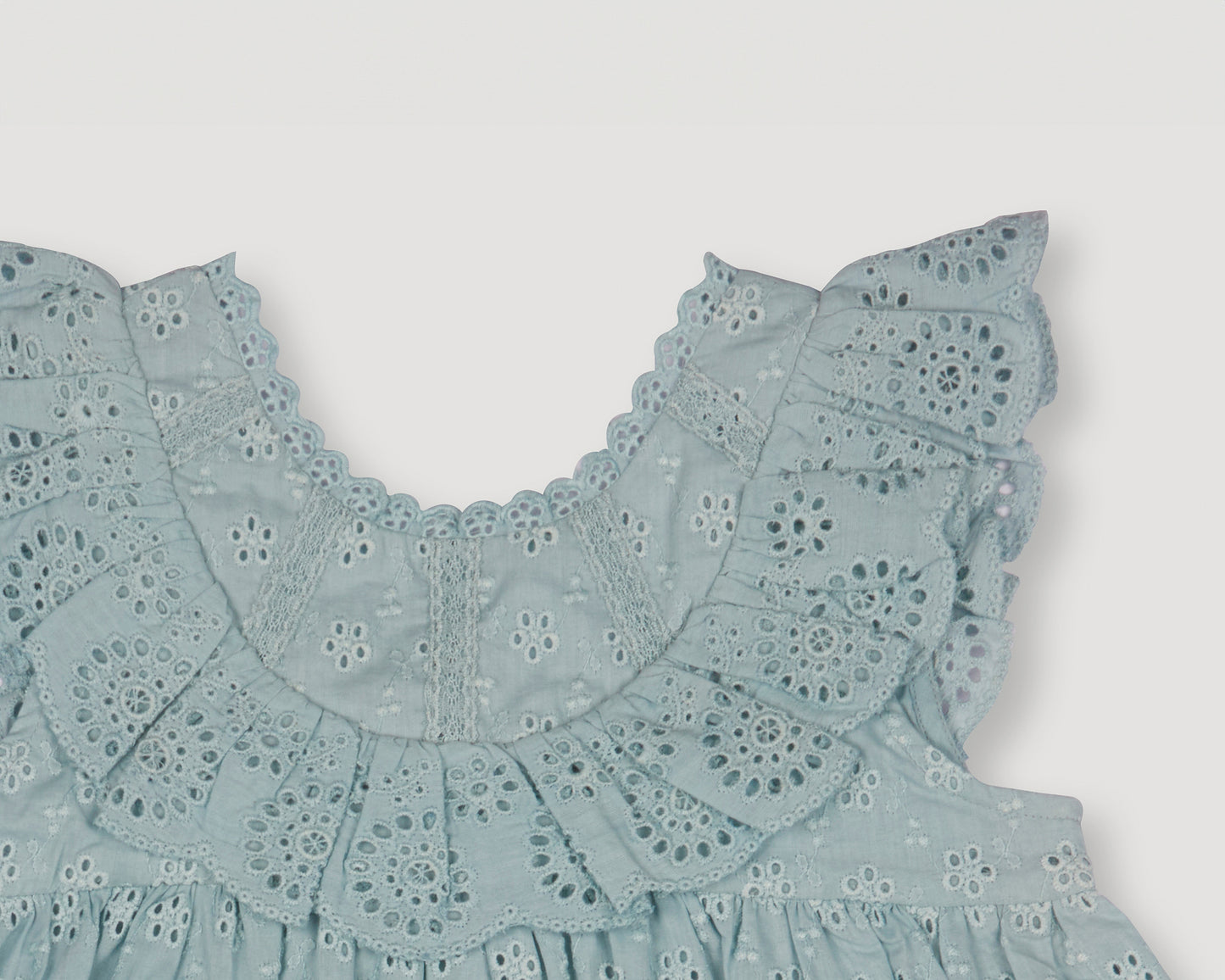 Early Sunday, Natasha Dress in Sea Dream color, made from All-Over Eyelet Embroidered Cotton Schifflie fabric, featuring flattering fit with delicate finishes, combining style and functionality for an effortlessly elegant look, shown in a closeup flat-lay view