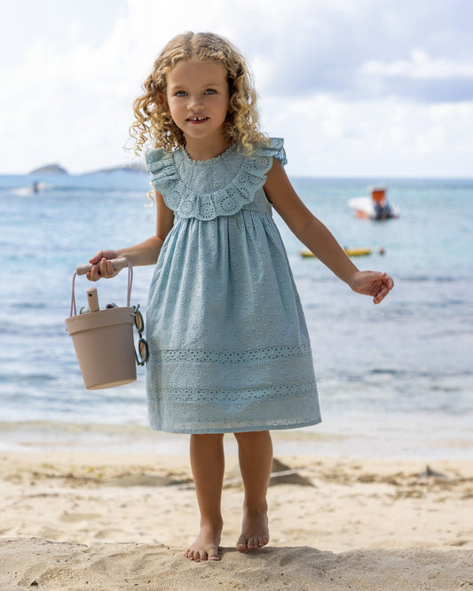 Early Sunday, Natasha Dress in Sea Dream color, made from All-Over Eyelet Embroidered Cotton Schifflie fabric, featuring flattering fit with delicate finishes, combining style and functionality for an effortlessly elegant look, shown in a front view of model wearing it