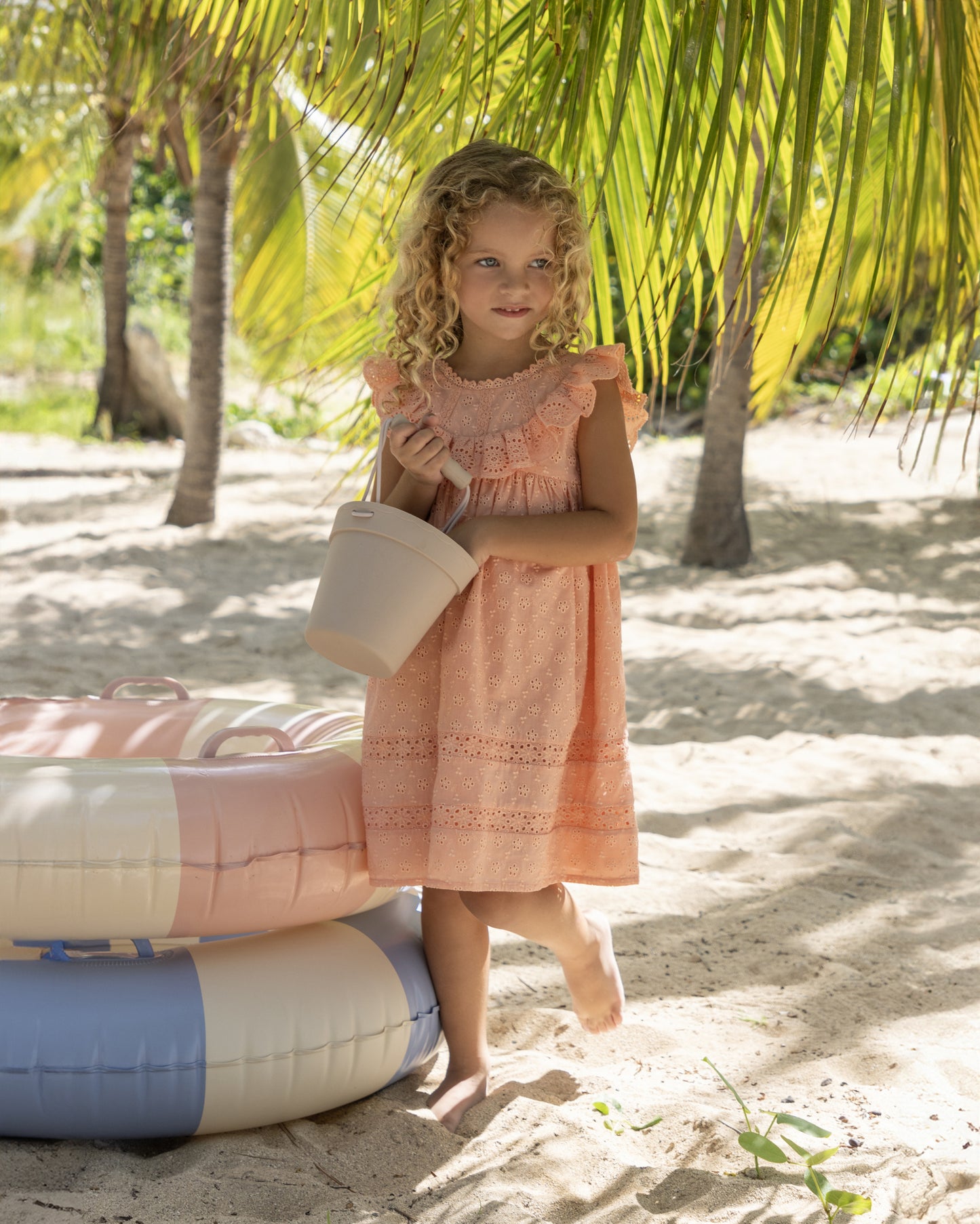 Early Sunday, Natasha Dress in Strawberry color, made from All-Over Eyelet Embroidered Cotton Schifflie fabric, featuring flattering fit with delicate finishes, combining style and functionality for an effortlessly elegant look, shown in a front view of model wearing it