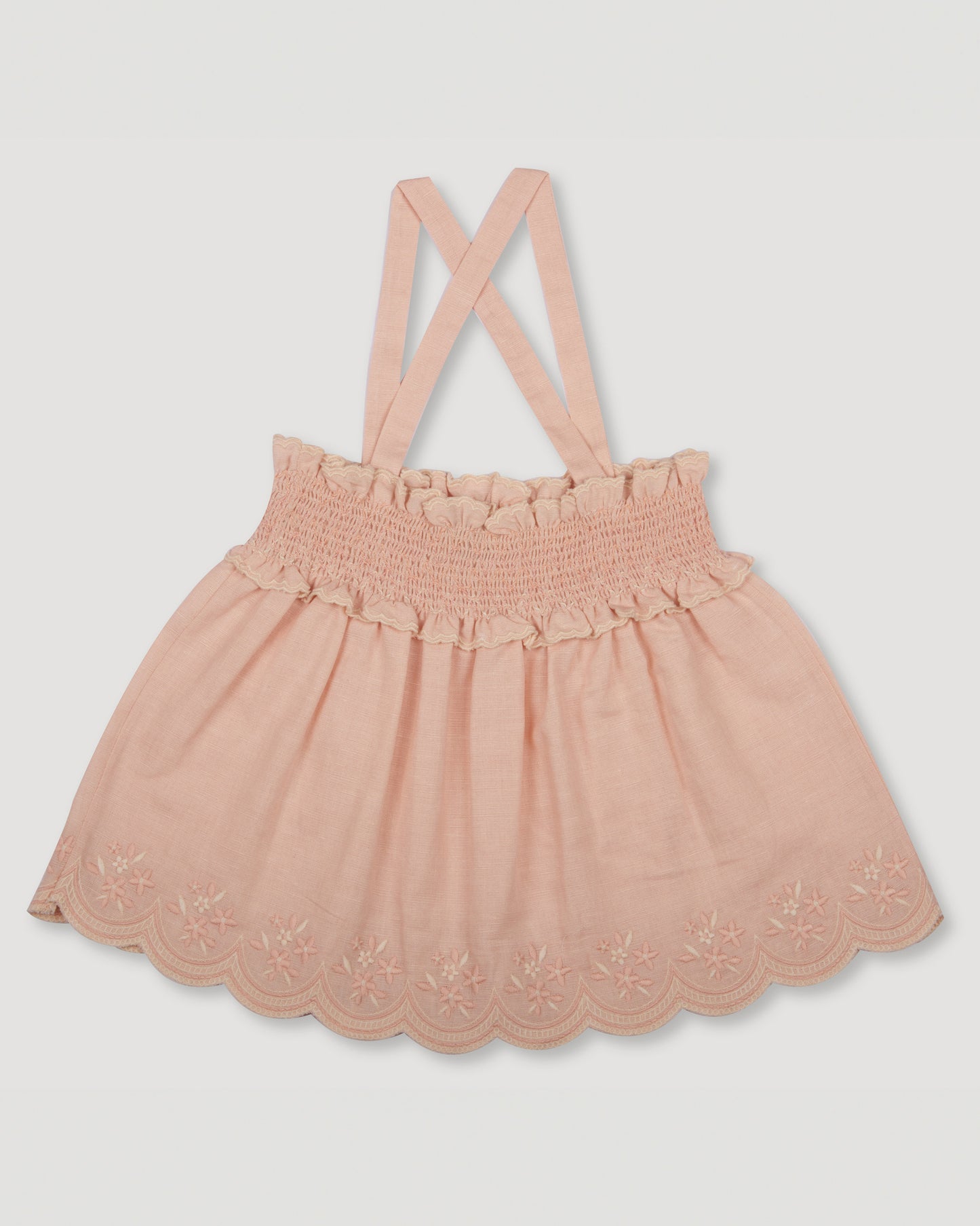 Early Sunday, Olivia Blouse in Pink Sand color, made from Canvas 70% Cotton 30% Linen fabric, featuring smocked bodice for a flexible fit, cross-back strap sand a flared hem, shown in a back flat lay view