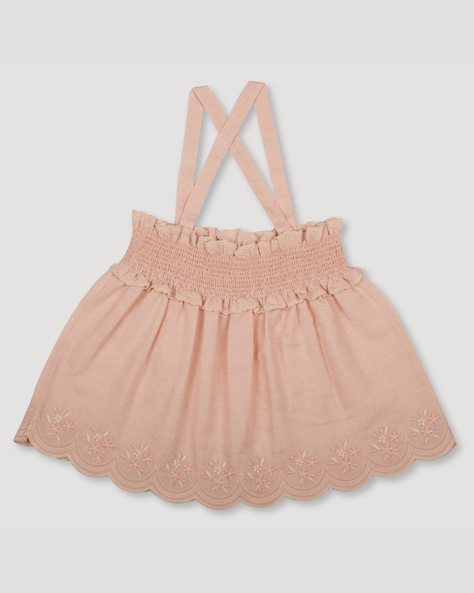 Early Sunday, Olivia Blouse in Pink Sand color, made from Canvas 70% Cotton 30% Linen fabric, featuring smocked bodice for a flexible fit, cross-back strap sand a flared hem, shown in a back flat lay view