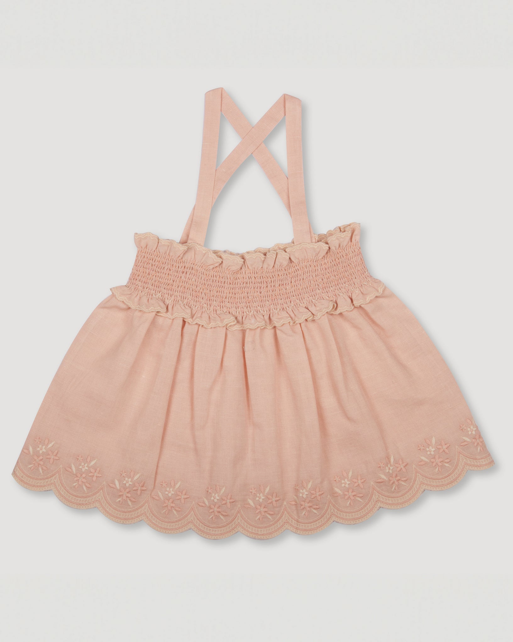 Early Sunday, Olivia Blouse in Pink Sand color, made from Canvas 70% Cotton 30% Linen fabric, featuring smocked bodice for a flexible fit, cross-back strap sand a flared hem, shown in a front flat lay view