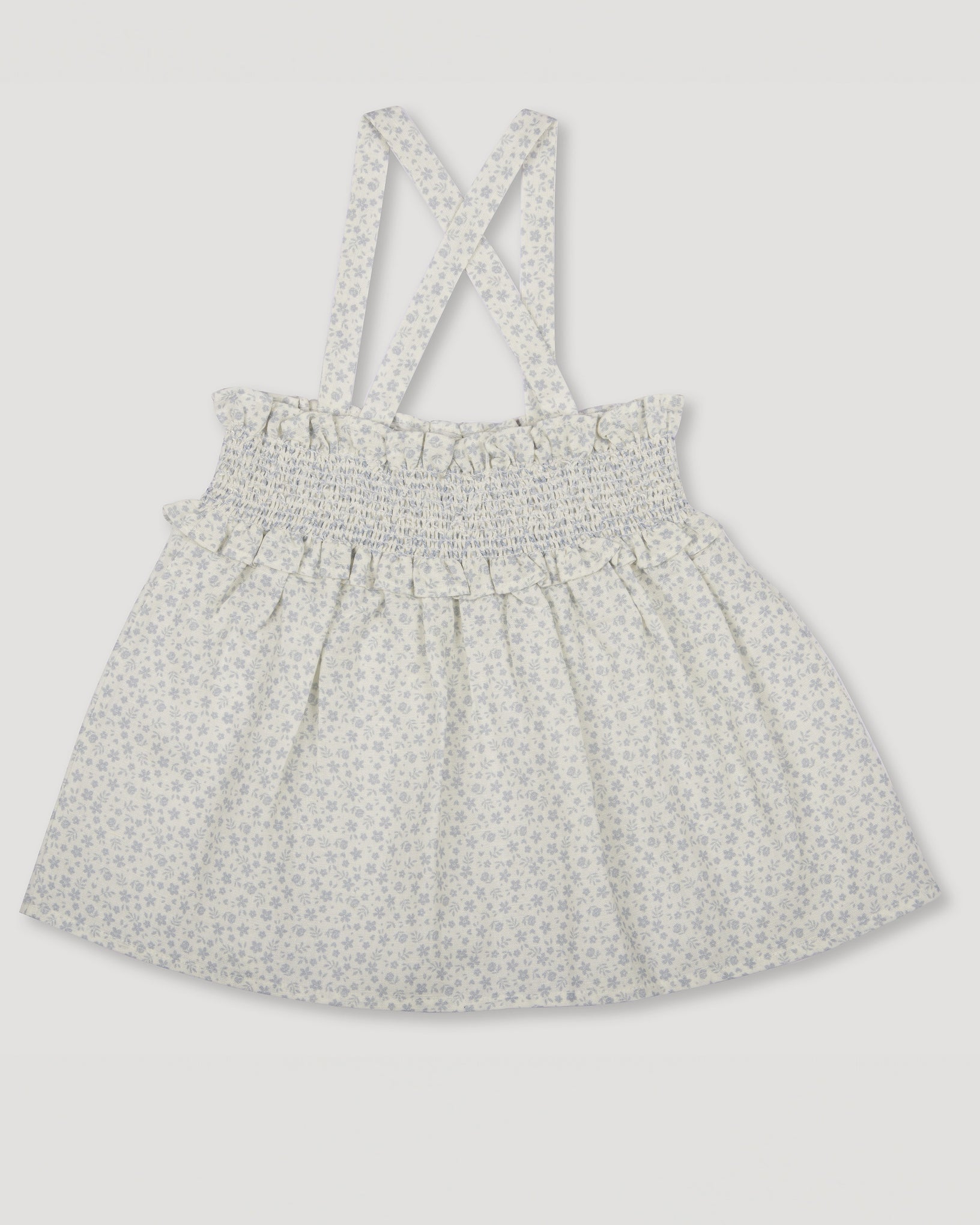 Early Sunday, Olivia Blouse in Mini Flower print, made from Printed canvas 70% Cotton 30% Linen fabric, featuring smocked bodice for a flexible fit, cross-back straps and a flared hem shown in a front flat-lay view