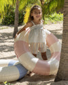 Early Sunday, Olivia Blouse in Mini Flower print, made from Printed canvas 70% Cotton 30% Linen fabric, featuring smocked bodice for a flexible fit, cross-back straps and a flared hem, shown in a front view of model wearing it