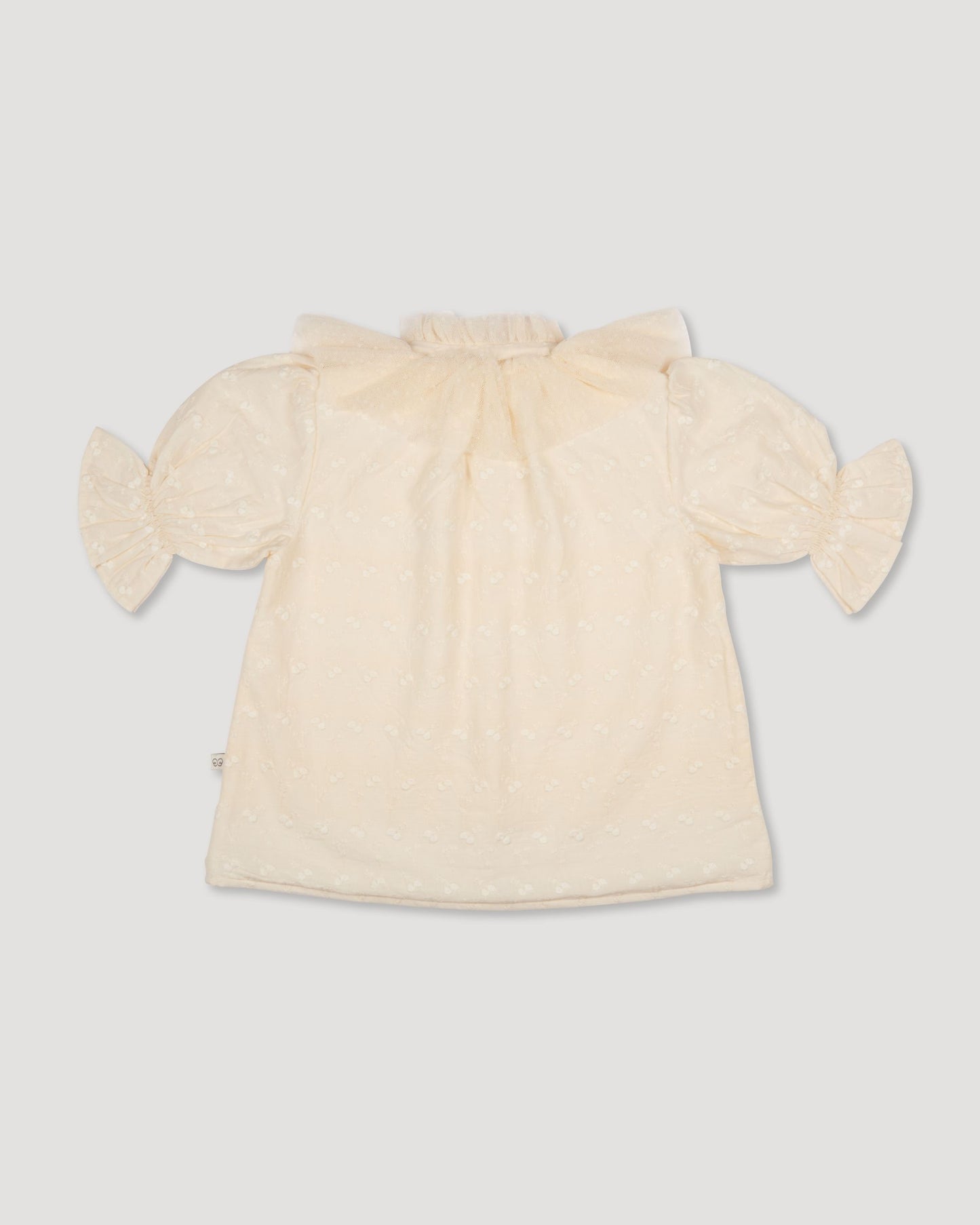 Early Sunday, Ophelie Blouse in Hazelnut Cream, made from All-Over Embroidered Cotton Cambric fabric, featuring Comfort-first design with a playful silhouette and French seams, shown in a back flat-lay view