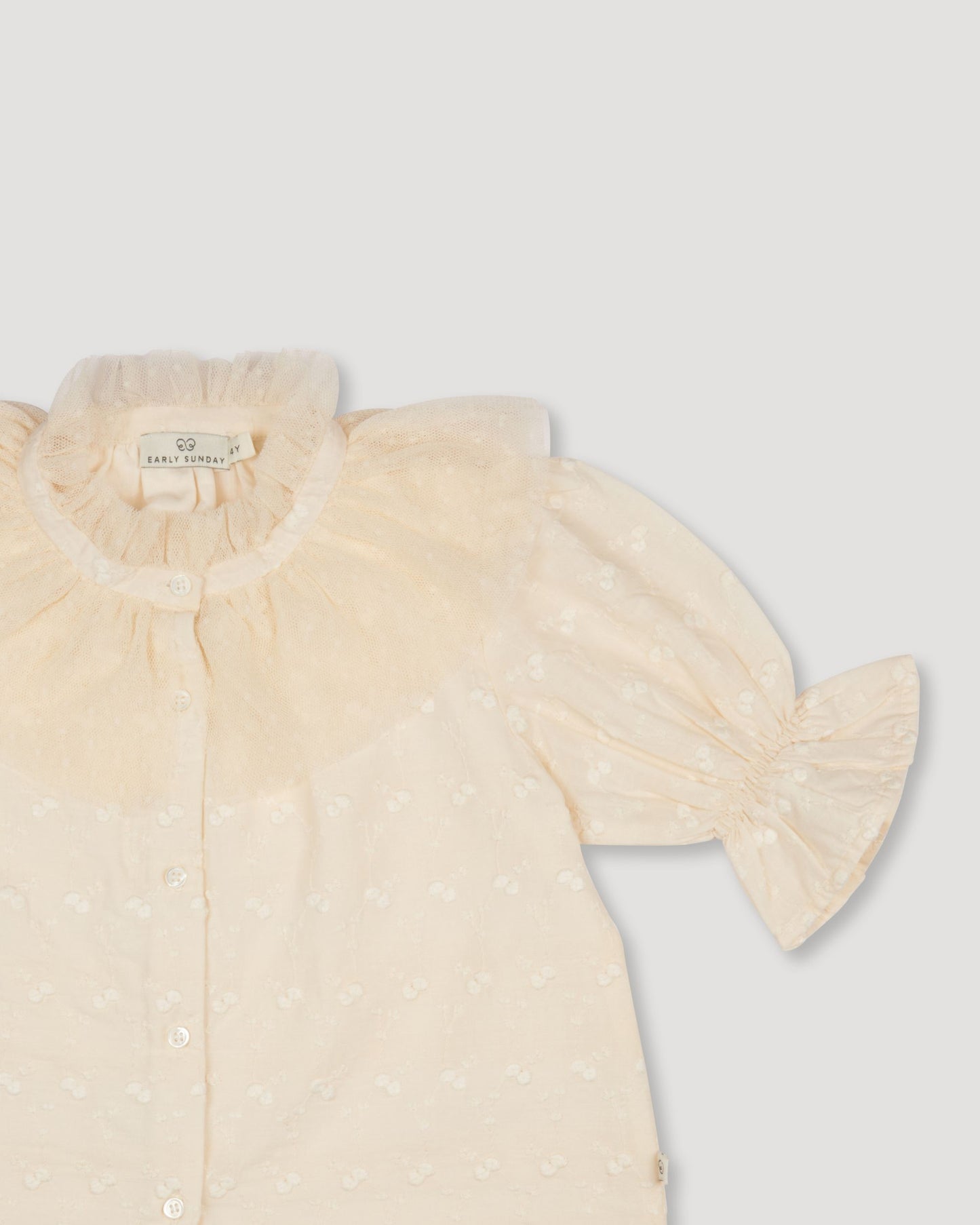 Early Sunday, Ophelie Blouse in Hazelnut Cream, made from All-Over Embroidered Cotton Cambric fabric, featuring Comfort-first design with a playful silhouette and French seams, shown in a closeup flat-lay view