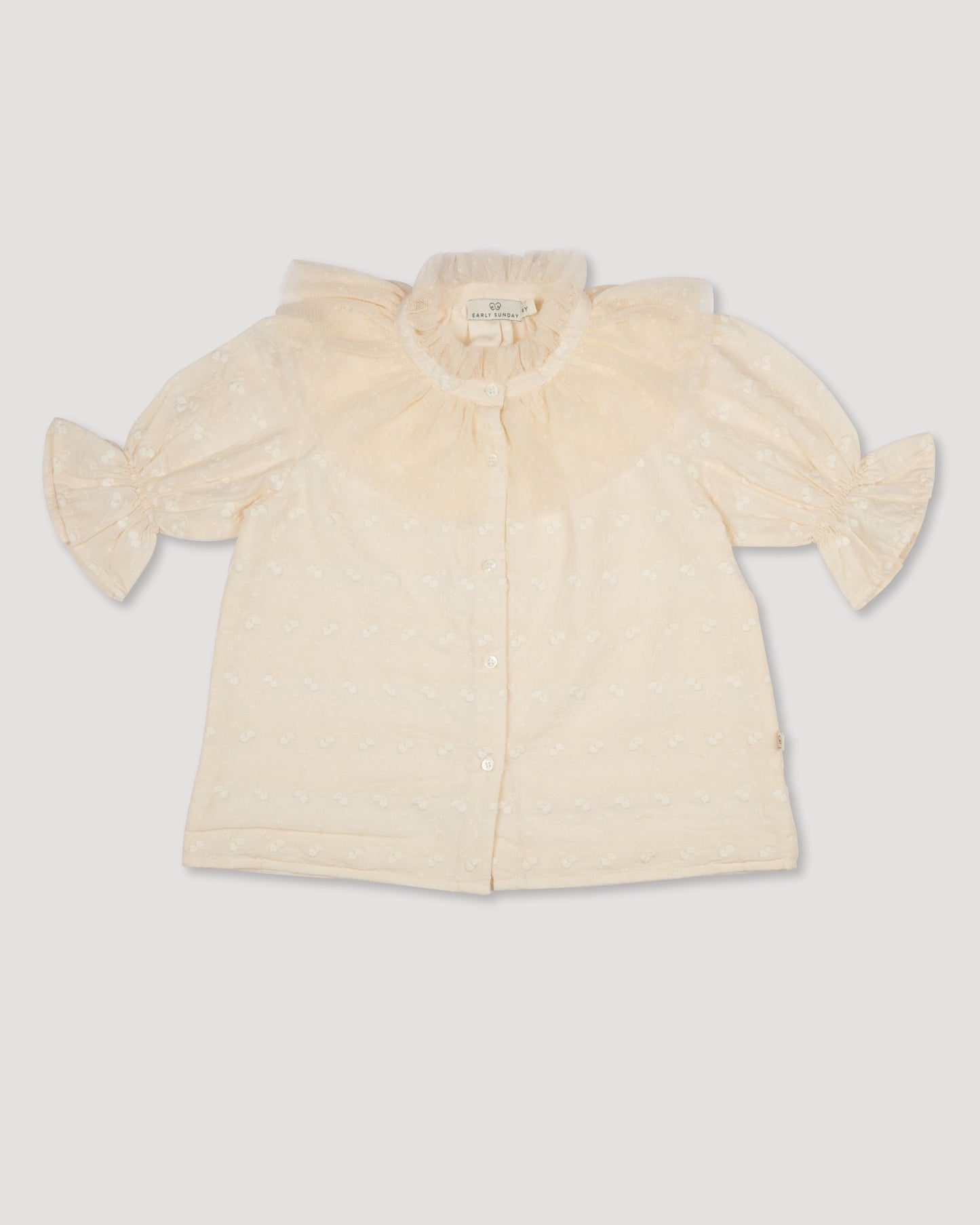 Early Sunday, Ophelie Blouse in Hazelnut Cream, made from All-Over Embroidered Cotton Cambric fabric, featuring Comfort-first design with a playful silhouette and French seams, shown in a front flat-lay view