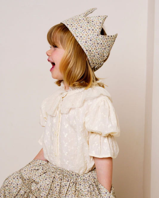 Early Sunday, Ophelie Blouse in Hazelnut Cream, made from All-Over Embroidered Cotton Cambric fabric, featuring Comfort-first design with a playful silhouette and French seams, shown in a close up shot of model wearing it