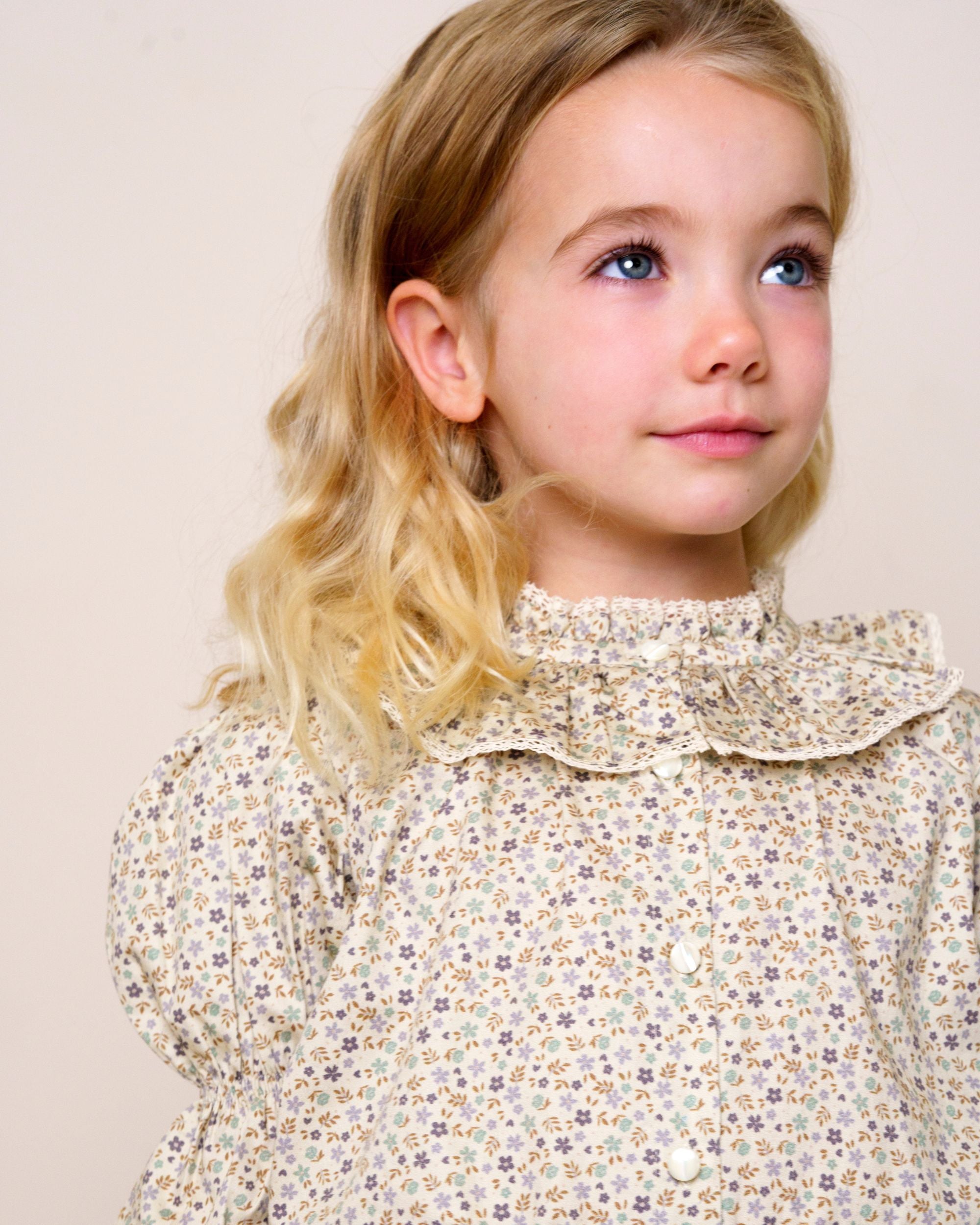 Early Sunday, Ophelie Blouse in Miny Flowers print, made from Printed Cotton Satin fabric, featuring Comfort-first design with a playful silhouette and French seams, shown in a close up shot of model wearing it