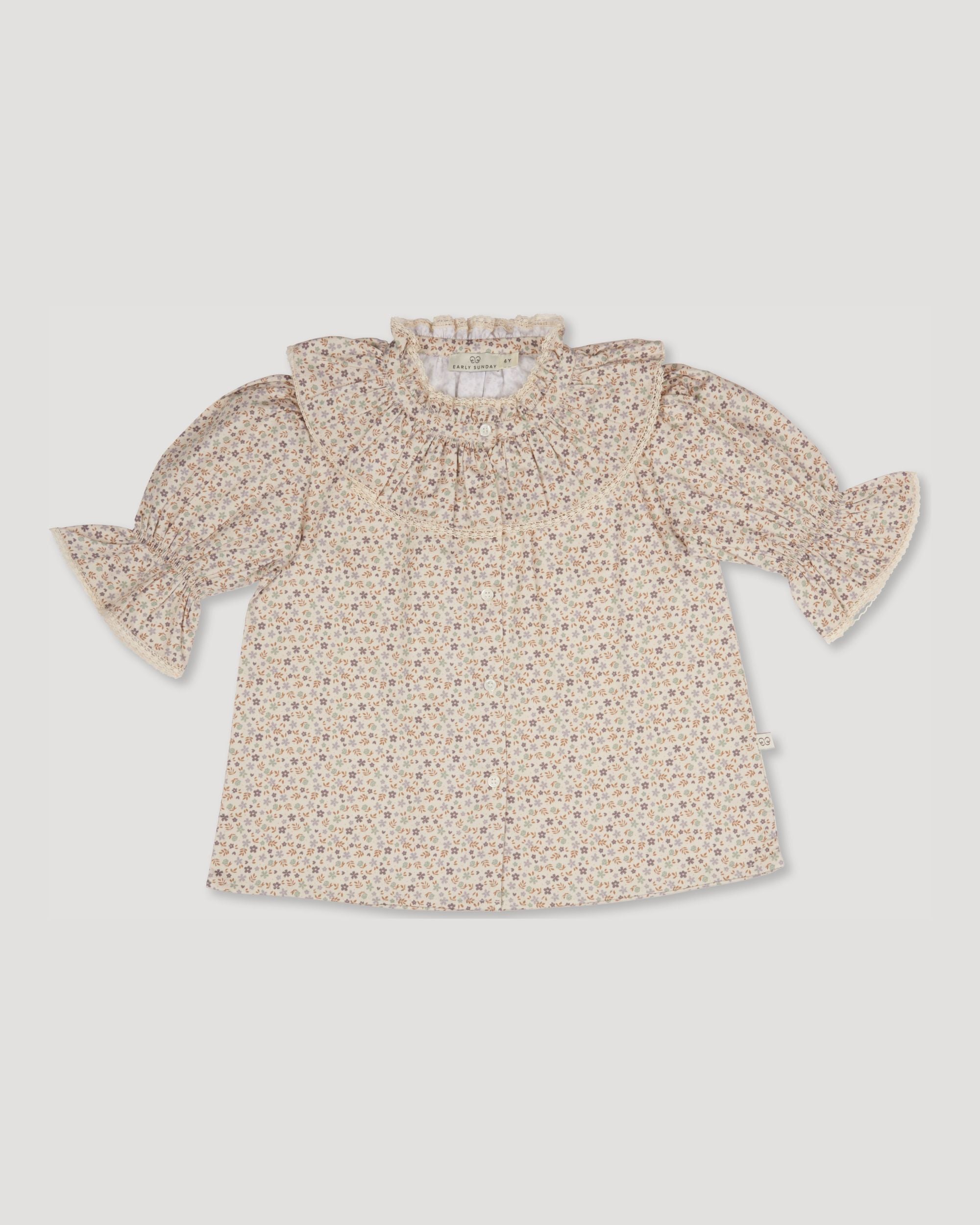 Early Sunday, Ophelie Blouse in Miny Flowers print, made from Printed Cotton Satin fabric, featuring Comfort-first design with a playful silhouette and French seams, shown in a front flat-lay view