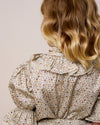 Early Sunday, Ophelie Blouse in Miny Flowers print, made from Printed Cotton Satin fabric, featuring Comfort-first design with a playful silhouette and French seams, shown in a back view of model wearing it