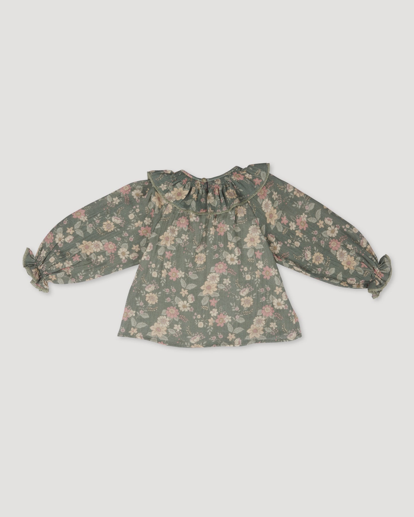 Early Sunday, Paloma Blouse in Autumn Bloom Soft Green, made from Printed Cotton Double Gauze fabric, featuring relaxed fit with a ruffle neckline, shown in a back flat-lay view