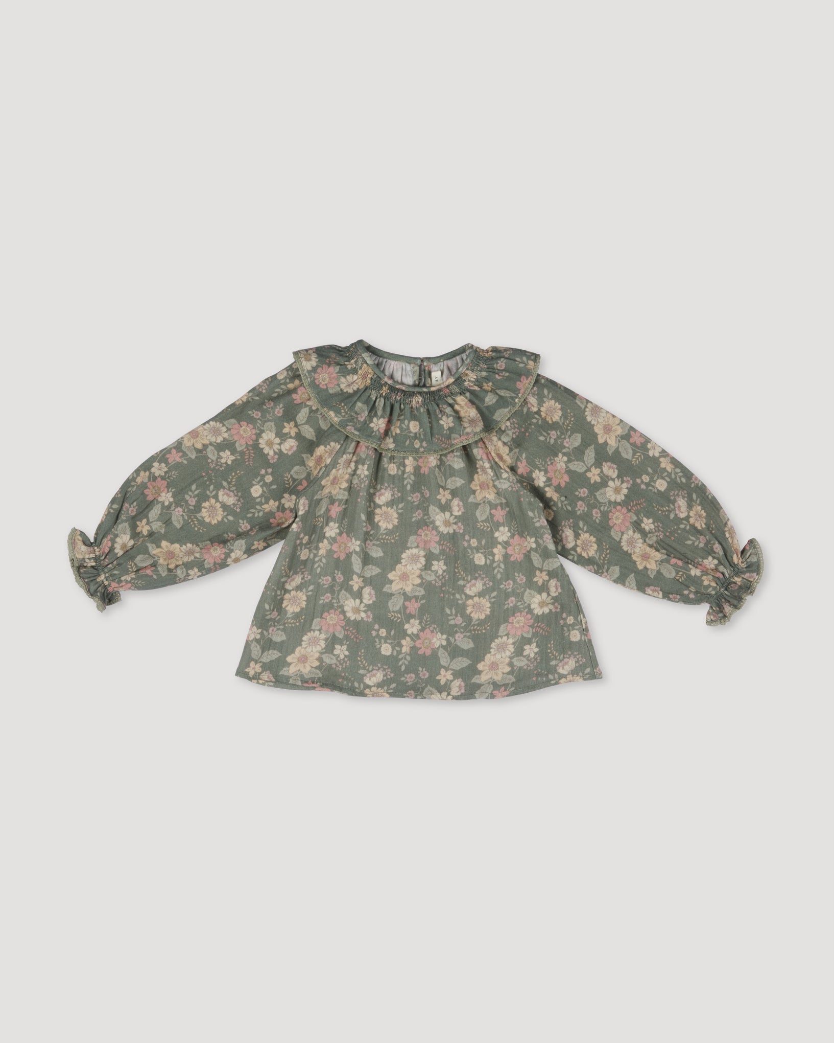 Early Sunday, Paloma Blouse in Autumn Bloom Soft Green, made from Printed Cotton Double Gauze fabric, featuring relaxed fit with a ruffle neckline, shown in a front flat-lay view