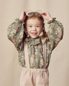 Early Sunday, Paloma Blouse in Autumn Bloom Soft Green, made from Printed Cotton Double Gauze fabric, featuring relaxed fit with a ruffle neckline, shown in a front view of model wearing it