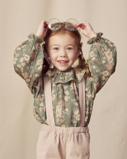 Early Sunday, Paloma Blouse in Autumn Bloom Soft Green, made from Printed Cotton Double Gauze fabric, featuring relaxed fit with a ruffle neckline, shown in a front view of model wearing it