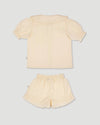 Early Sunday, Peggy Pyjama Set in Hazelnut Cream, made from Dyed Cotton Swiss Dobby Tiny Dots fabric, featuring Button-down shirt with classic tailoring, subtle gathers, and gentle volume, shown in a back flat-lay view