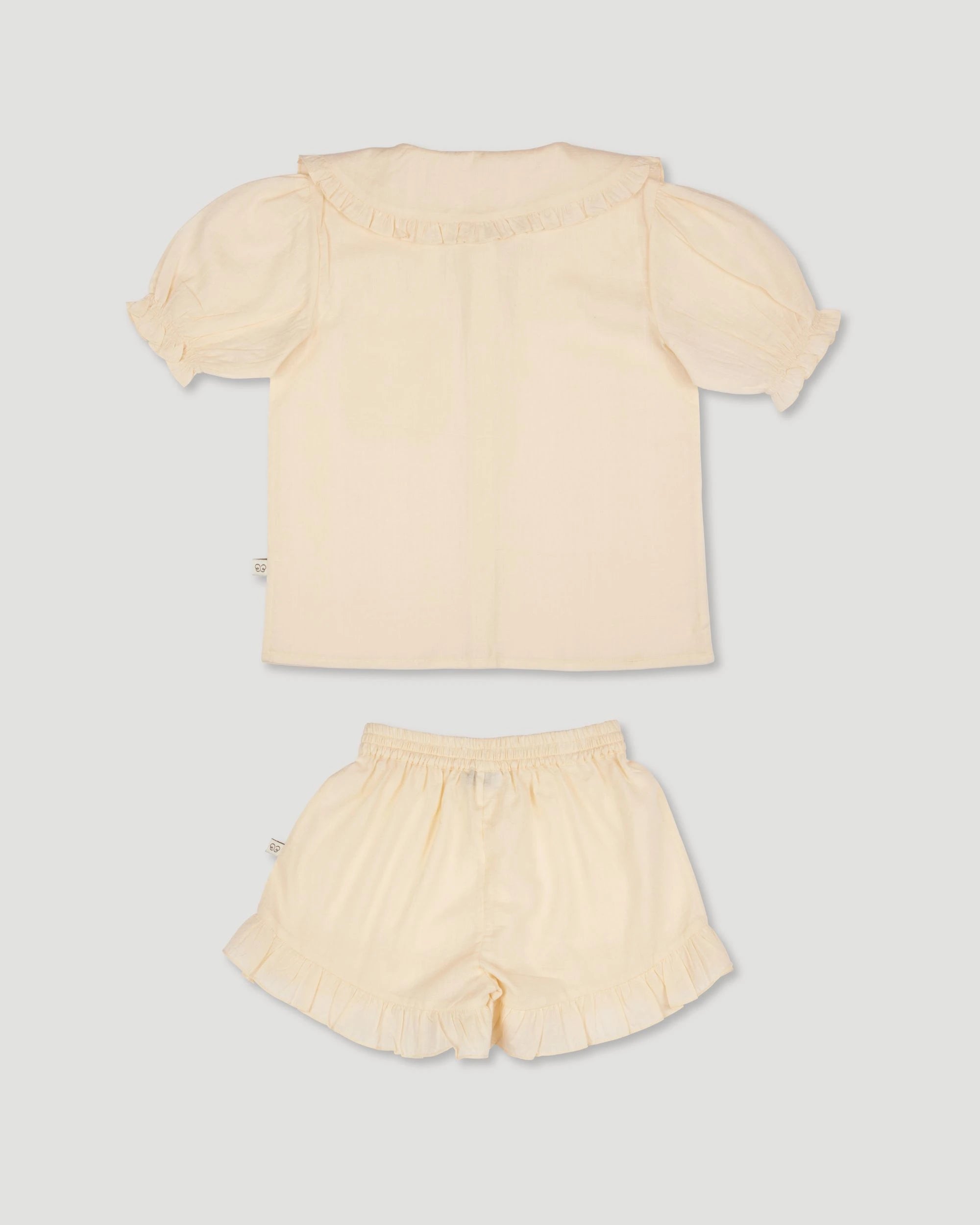Early Sunday, Peggy Pyjama Set in Hazelnut Cream, made from Dyed Cotton Swiss Dobby Tiny Dots fabric, featuring Button-down shirt with classic tailoring, subtle gathers, and gentle volume, shown in a back flat-lay view