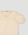 Early Sunday, Peggy Pyjama Set in Hazelnut Cream, made from Dyed Cotton Swiss Dobby Tiny Dots fabric, featuring Button-down shirt with classic tailoring, subtle gathers, and gentle volume, shown in a closeup flat-lay view