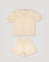 Early Sunday, Peggy Pyjama Set in Hazelnut Cream, made from Dyed Cotton Swiss Dobby Tiny Dots fabric, featuring Button-down shirt with classic tailoring, subtle gathers, and gentle volume, shown in a front flat-lay view
